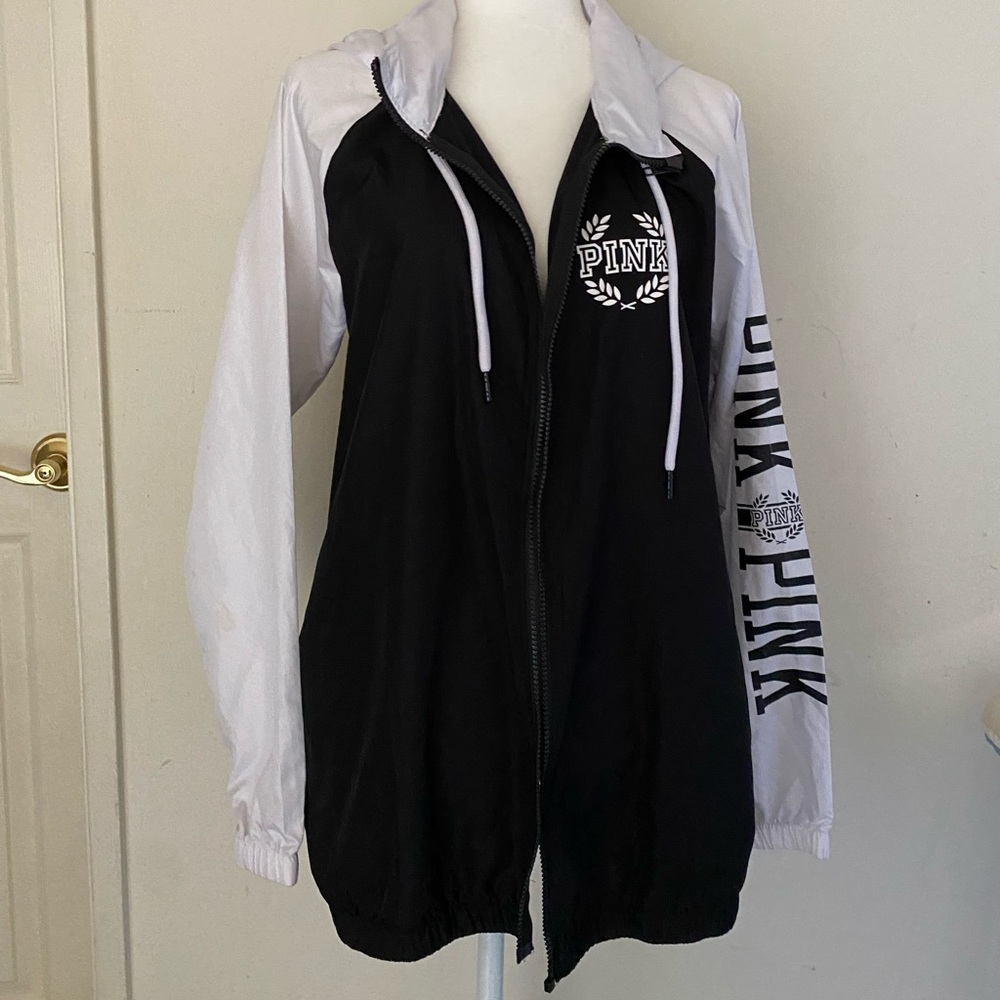 Medium/Large black and white windbreaker with a hide away hood